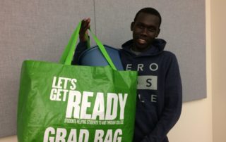 A student shows his Grad Bag to the camera.